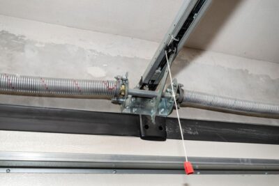 garage door repair in Sacramento technician fixing spring and track system